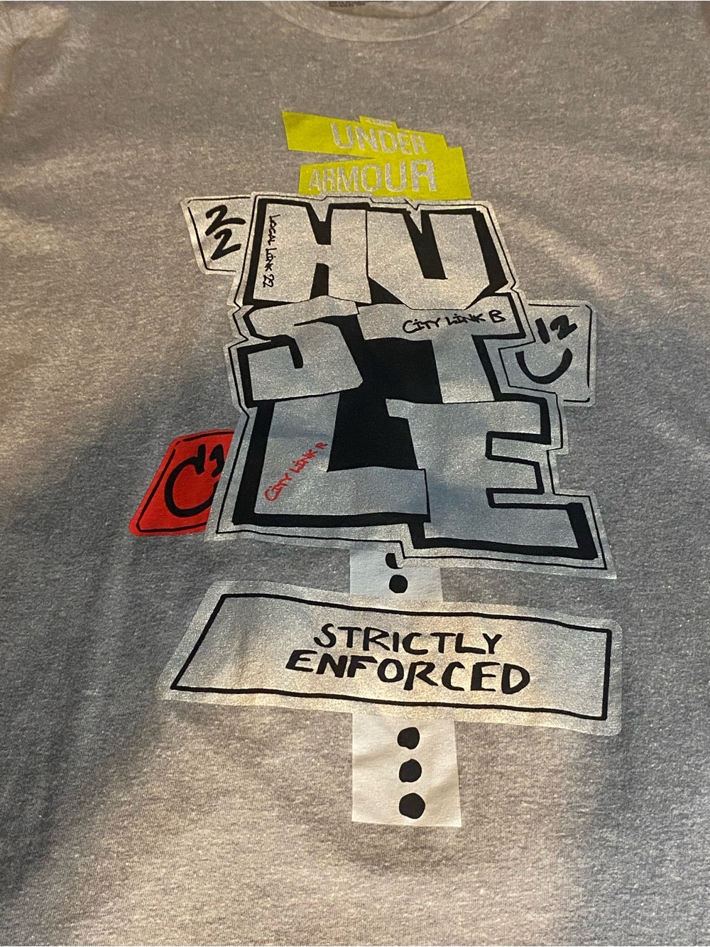 Under Armour Grey Short-Sleeve 'HUSTLE' Graphic Tee with Yellow & Red Accents